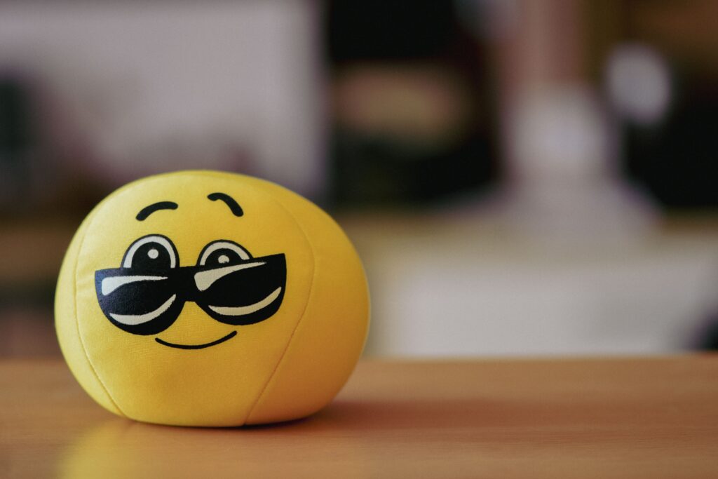 A cheerful yellow emoji ball with sunglasses, perfect for playful and fun themes.